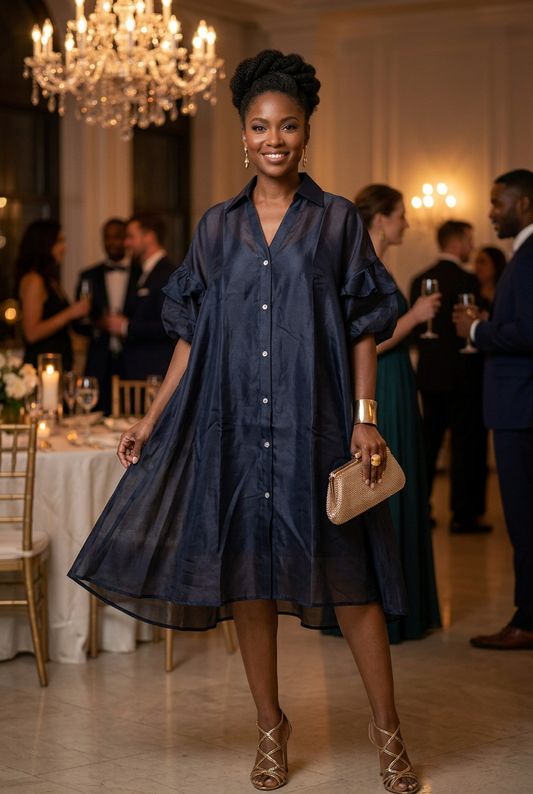 Evening look with gold statement earrings, cuff bracelet, cocktail ring, clutch, and strappy heels